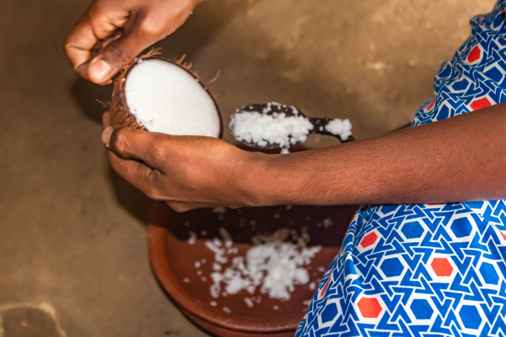 Woman,Hands,Grating,A,Coconut,During,A,Village,Safari,In